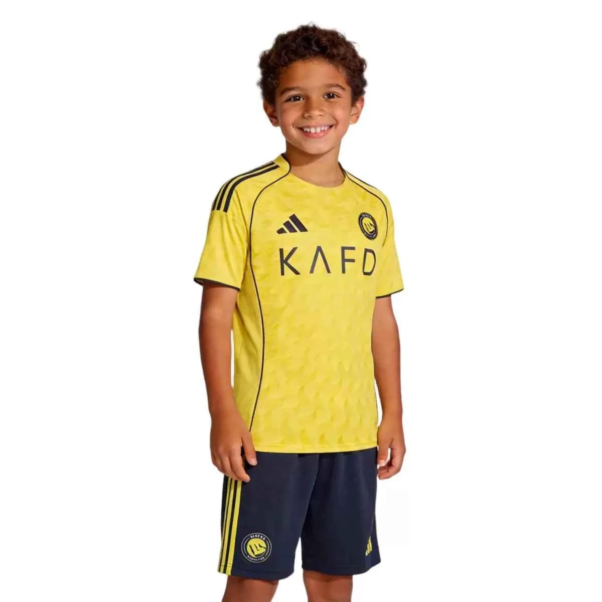 ce31ea11c91e288edf7eeb969067fb439c77acd0ed9_e1cc4zo12vvl12vvufowebp.jpg Kids Al Nassr Home Jersey Kit 2025/26 - Image 1